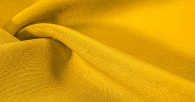 Arka plan dokusu, desen. Metalik pullu sarı kumaş. Bu güzel, hafif pullu kumaşın notaları, pullu aksanı ve güzel bir tasarımı var. Ayrıca güzel bir parıltısı var..