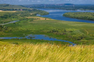 Yaz manzarası, bir kanaldan denize, bir göle ya da başka bir dereye akan büyük bir doğal su akıntısı. Sel, nulla, sıvı, ford. Yüksek tepe kıyıları
