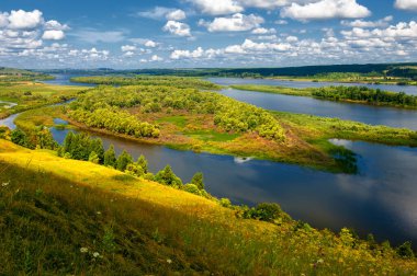 Yaz manzarası, bir kanaldan denize, bir göle ya da başka bir dereye akan büyük bir doğal su akıntısı. Sel, nulla, sıvı, ford. Yüksek tepe kıyıları