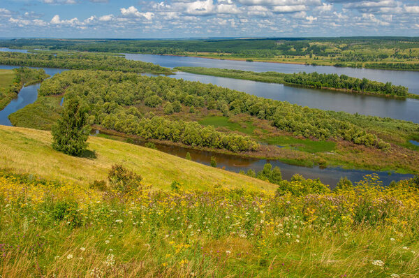 Summer landscape, river a large natural stream of water flowing in a channel to the sea, a lake, or another such stream. flood, nulla, effluent, ford. High hilly shores