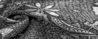 Arka plan tasarım dokusu, siyah-beyaz, beyaz çiçek çizimleri olan ipek kumaş. Charmeus 'un çok güzel bir kumaşı var. Yumuşak bir doluluk içinde birleştirilebilir..