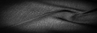 Arkaplan dokusu koyu siyah şifon ipeği yumuşak şeffaf bir kumaştır ve pürüzlüdür (matte, creped) çünkü bükülmüş iplik kullanımı.