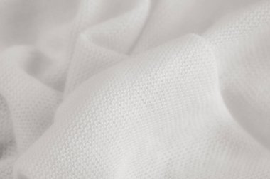 Beyaz kumaş. Lüks kumaşın soyut arka planı ya da dalgaların sıvı ipek dokusu ya da dalgalı kıvrımlar. arka plan ya da zarif duvar kağıdı tasarımı. Pamuk dokusu, doğal kumaş ve boya, parlak beyaz renk..