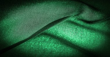 Arkaplan dokusu Koyu yeşil şifon ipeği hafif pürüzlü yumuşak şeffaf bir kumaştır (matte, creped) bükülmüş iplik kullanımı nedeniyle.