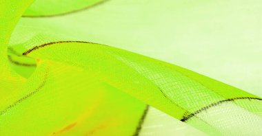 Arka plan dokusu bir organza deseni. İnce, şeffaf kumaştan bir kumaş. İnce, yapışkan ipekten bir peçe gibi. yeşil beyaz sarı gri geometrik renkler