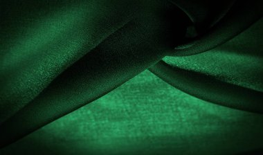 Arkaplan dokusu Koyu yeşil şifon ipeği hafif pürüzlü yumuşak şeffaf bir kumaştır (matte, creped) bükülmüş iplik kullanımı nedeniyle.