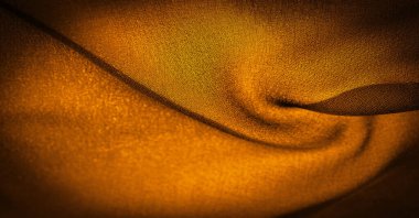 Arka plan dokusu koyu sepia kahverengi şifon ipeği yumuşak şeffaf bir kumaştır ve pürüzlüdür (matte, creped) çünkü bükülmüş iplik kullanımı.