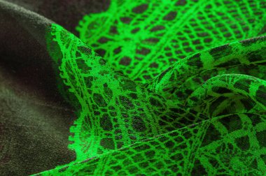 Doku, arka plan, desen. Zümrüt yeşili dantel kumaş. Siyah kumaşla yeşil kumaşın karışımı. Verdant, lawny, virid, dana eti