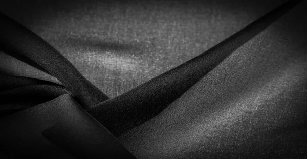 背景の質感ダークブラックのシフォンシルクは ツイスト糸の使用により若干のラフネス マット クリップ を持つ柔らかい透明生地です — ストック写真