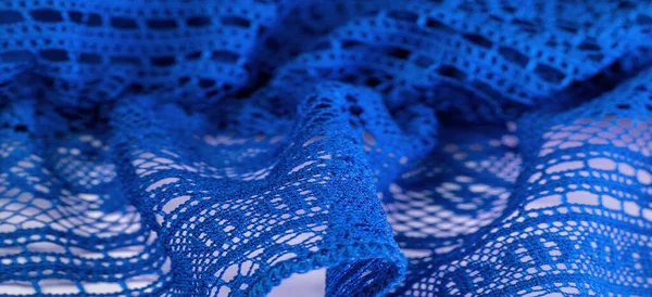 Background, texture, pattern, blue lace fabric, thin open fabric, usually made of cotton or silk, made using loops, twisting or knitting threads in patterns