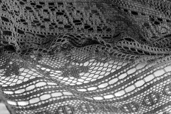 Background, texture, pattern, black lace fabric, thin open fabric, usually made of cotton or silk, made using loops, twisting or knitting threads in patterns