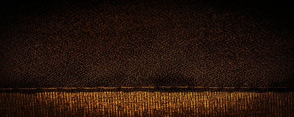 Background texture Dark sepia brown-yellow chiffon silk is a soft transparent fabric with a slight roughness (matte, creped) due to the use of twisted yarn.