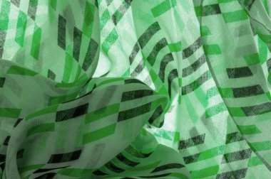 Doku. Geçmişi. Şablon. Yeşil ve siyah geometrik eşkenar dörtgen şekilli beyaz ipek kumaş.