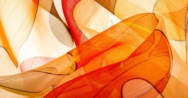 Arka plan dokusu bir organza deseni. İnce, şeffaf kumaştan bir kumaş. İnce, yapışkan ipekten bir peçe gibi. yeşil kırmızı kırmızı geometrik renkler