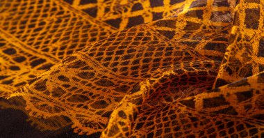 Doku, arka plan, desen. Altın dantel, siyah kumaşla sarı altın karışımı. kırmızı, ahtapot, metallerin kralı, toprak rengi