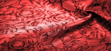 relief pattern, composite textiles, red silk fabric, with a floral pattern, unusually pleasant visual sensations: slippery, coolness, softness; beautiful appearance, unique luster;
