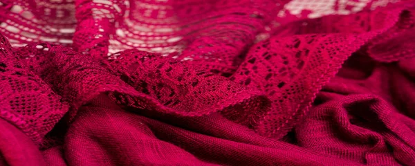 Background, texture, pattern, red lace fabric, thin open fabric, usually made of cotton or silk, made using loops, twisting or knitting threads in patterns
