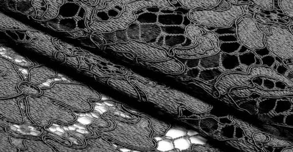 Texture, background, pattern, black lace fabric, delicate embossed lace fabric, scalloped on both edges. Suitable for your projects, design, etc.