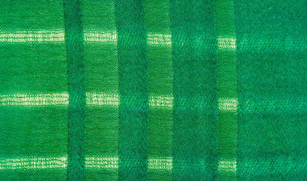 Texture, background, pattern, simple green fabric with lines. The lines formed by the extraction of the thread,
