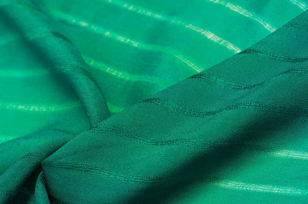 Texture, background, pattern, simple green fabric with lines. The lines formed by the extraction of the thread,