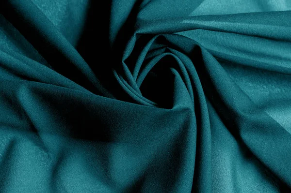 Textured, background, pattern, turquoise fabric. This is an unusual fabric that has an elegant appearance with a rich and coarse texture. It is tightly knit with designs built into the fabric itself
