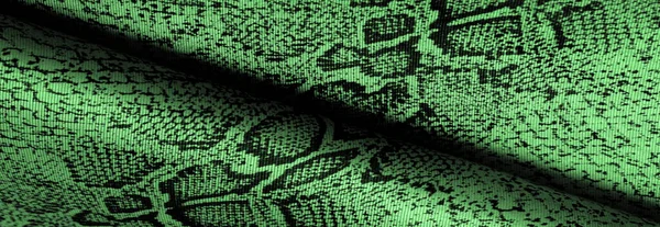 Texture, background, pattern, fabric with a green snake skin pattern, African fabric, designer photo - safari in the country of Africa