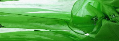 Arkaplan tasarımı dokusu, ipek desen, yeşil kumaş ve dekoratif işlemeli taşlar.