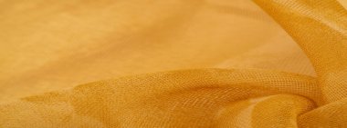 Arkaplan tasarımı dokusu, ipek desen, sarı kumaş ve dekoratif işlemeli taşlar.