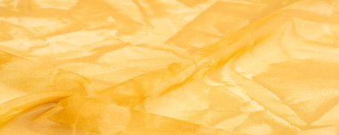 Arkaplan tasarımı dokusu, ipek desen, sarı kumaş ve dekoratif işlemeli taşlar.