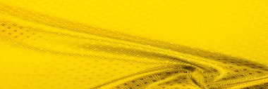 Arka plan dokusu, desen. Sarı, hardallı ipek kumaş, küçük kareli desenli. Kıvılcımlı altyazılarla örülmüş boğuk sarı örgü. Parlak bir çizim tasarımı. Bireysel parçalar.