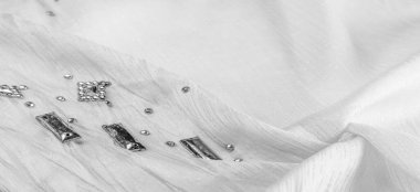 Arkaplan tasarımı dokusu, ipek desen, dekoratif taşlarla kaplı beyaz kumaş.