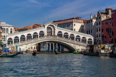 Venedik, İtalya - 23 Ekim 2018, Venedik şehrindeki Rialto Köprüsü yakınlarında tekne ve gondollar alabilen turistler. Turizm ve seyahat kavramı