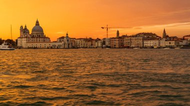 Venedik, İtalya - 23 Ekim 2018, Venedik şehrinde, Santa Maria della Salute Bazilikası'nın arka planına karşı Büyük Kanal üzerinde muhteşem bir gün batımı. Turizm ve seyahat kavramı