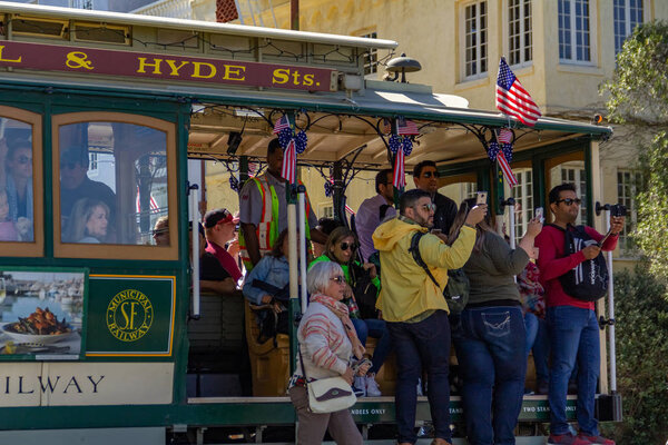 San Francisco, USA - July 18, 2019, people hang and take pictures of the sights in the old tram on the cable car in the city of San Francisco, close-up view, in clear sunny weather, concept, tourism