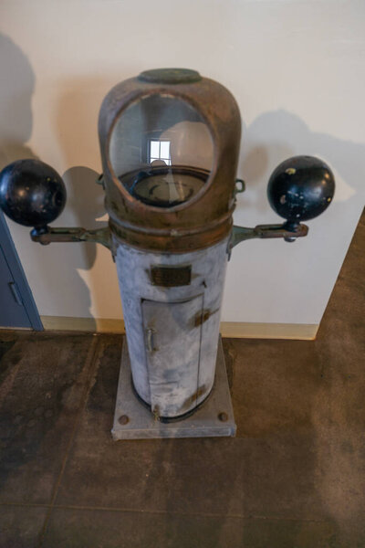Vintage binnacle ship compass with Kelvins balls correctors displayed at Point Sur Lighthouse Museum in Big Sur, California, USA. Historic maritime navigation instrument from naval heritage collection