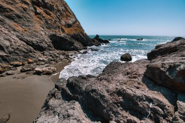 Rocky shoreline at Pirates Cove, reached via Tennessee Valley Trail in Marin Headlands, California. Rugged cliffs, boulders, and the Pacific Ocean waves create a wild coastal scene near San Francisco