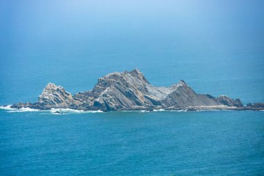 San Pedro Rock in the Pacific Ocean near Pacifica, California, along Highway 1, viewed from Gray Whale Cove Trail, showcasing rugged coastal cliffs, geology, and scenic seascape