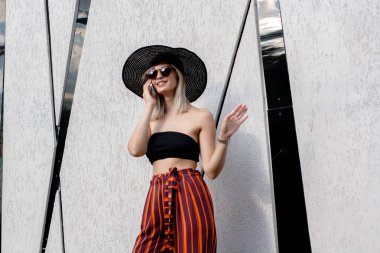 Şapka ve gözlük bir akıllı telefon kullanan genç şık güzel kadın selfie açık havada yapma