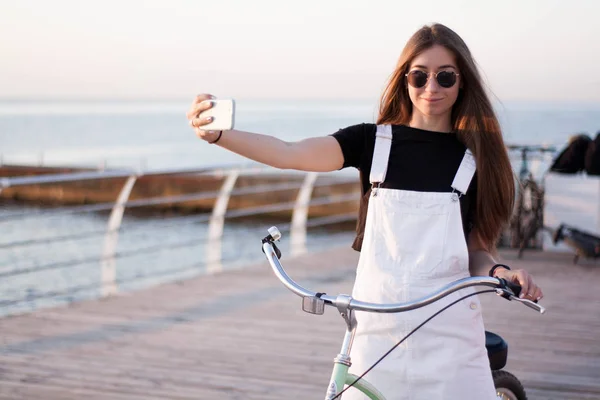 Hermosa Joven Con Una Bicicleta Divierte Utiliza Teléfono Inteligente Llamadas —  Fotos de Stock