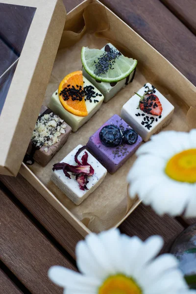 Raw vegan desserts in the box with fresh berries