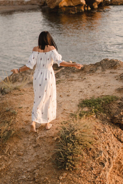 beautiful young brunete woman enjoys the beautiful view on the beach and has a good sunrise time. Relax