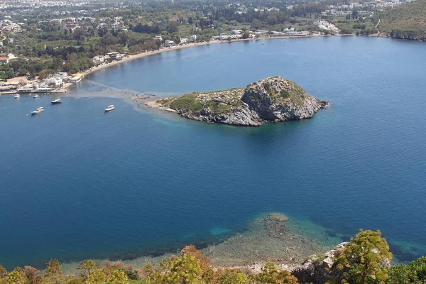 Aerial high angle view of Rabbit Island in Gumusluk bay, Bodrum. Gumusluk, a seaside village and fishing port in Turkey, is situated on the remains of the ancient city of Myndos