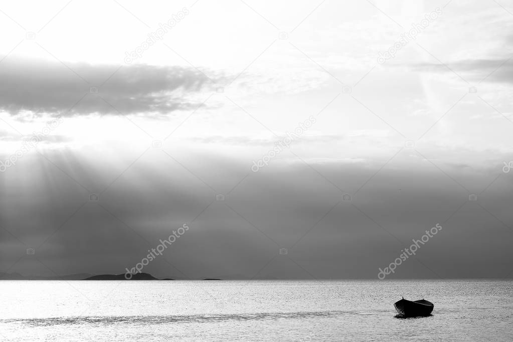 Sunset in the sea with a boat. A picture of a small boat with a beautiful sunset background