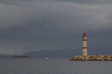 Gün batımında deniz manzarası. Sahildeki deniz feneri. Deniz kenti Turgutreis ve muhteşem gün batımları