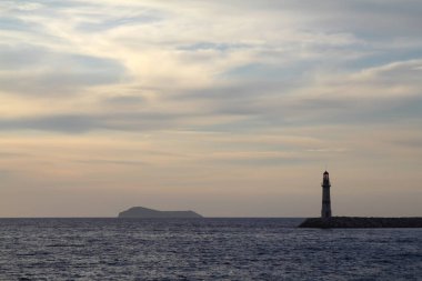 Gün batımında deniz manzarası. Sahildeki deniz feneri. Deniz kenti Turgutreis ve muhteşem gün batımları