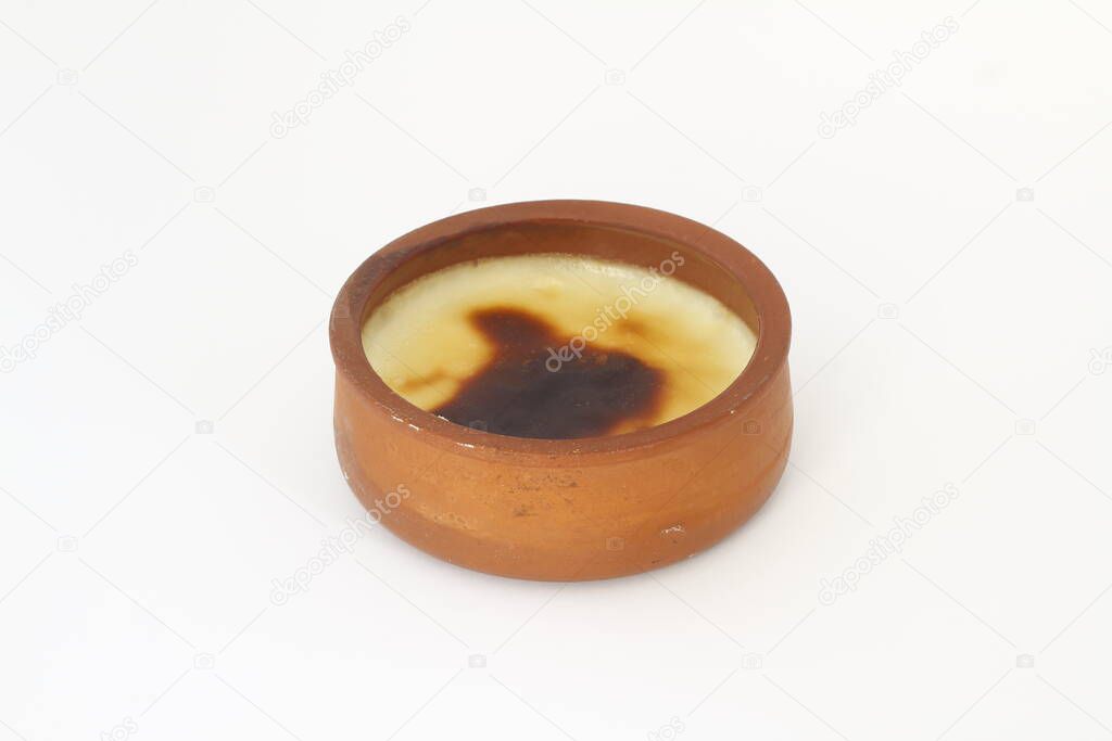 Traditional Turkish oven rice pudding in a earthenware bowl isolated on white background