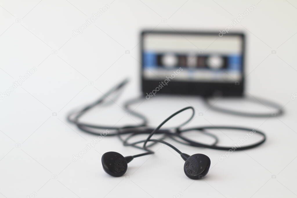 Blue -White audio cassette and cassette pleer with headphones on a white background. Party 90s concept