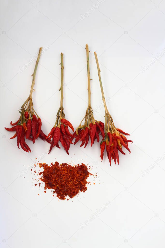 red dried crushed hot chili peppers and chili flakes or powder isolated on white background, healthy turkish spice