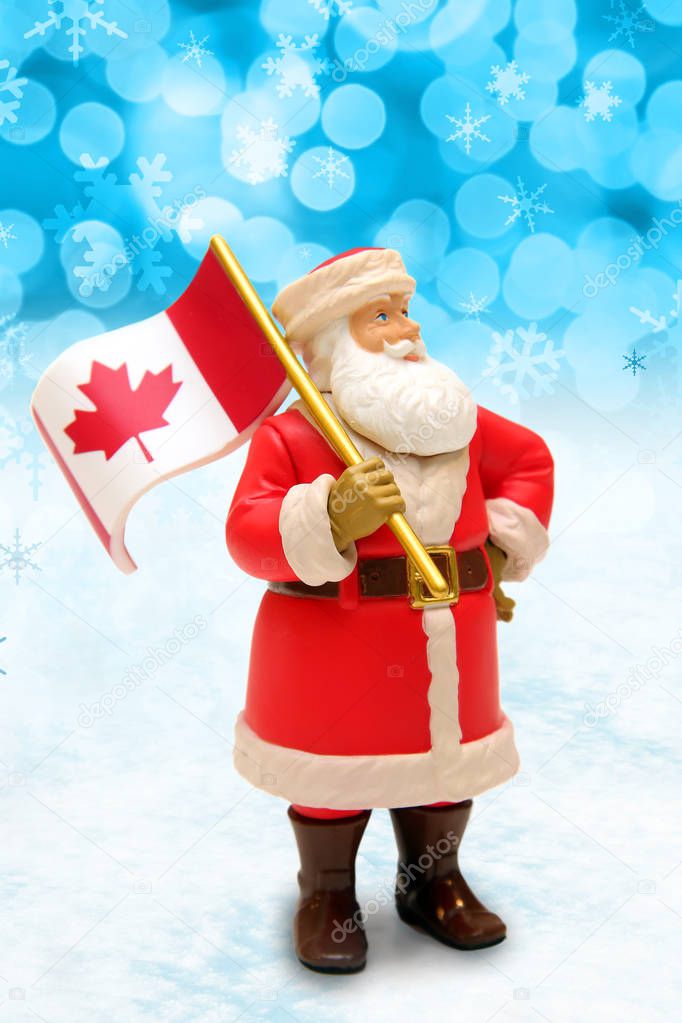 Christmas Santa Claus ornament holding a Canada maple leaf flag. 