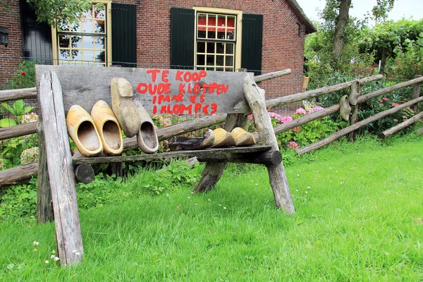 荷兰木鞋出售在荷兰的一条乡村街道的一侧 木符号翻译中的文本 免版税图库图片